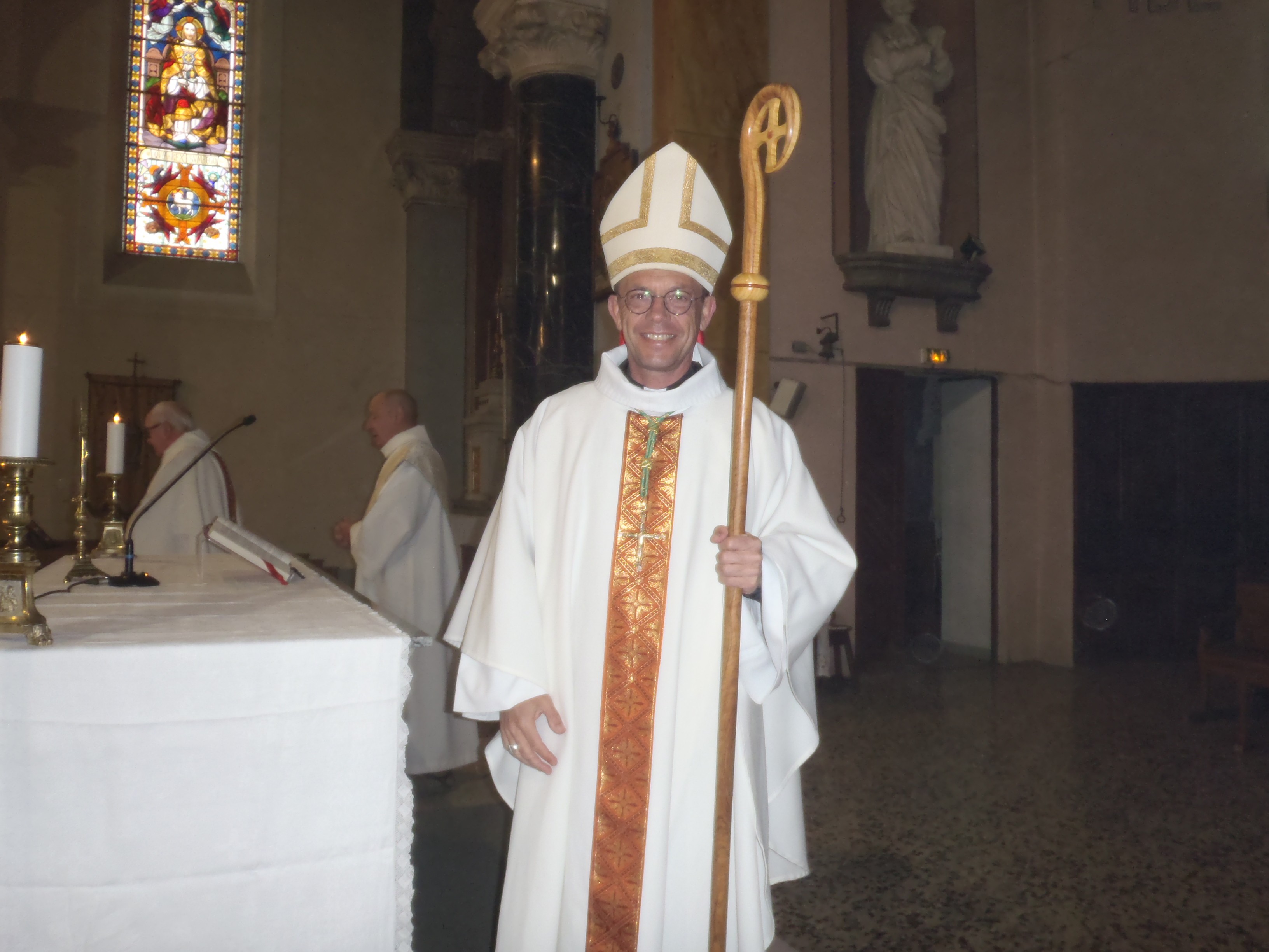 l'évêque arbore un sourire radieux à l'issue de la messe
